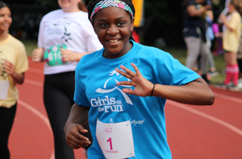 Girl waving at Finish Line